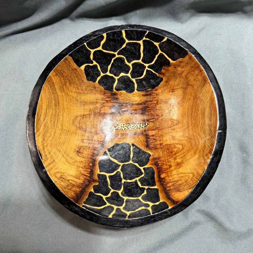 hand-carved wooden bowl featuring striking giraffe-print contrast patte